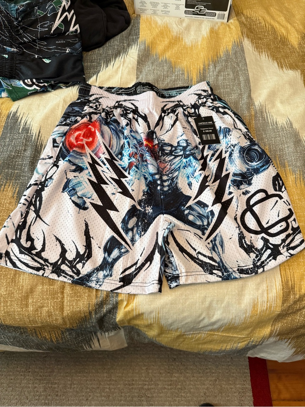 Corrupted Creative DC (Marvel) Graphic Mesh Shorts in White and Black with Blue